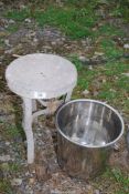 Galvanised milking stool and stainless steel bucket.