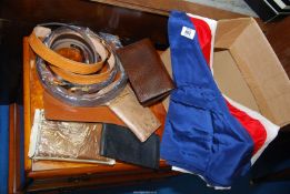 A quantity of leather belts, wallets and a flag.