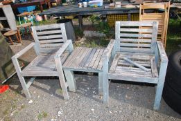 A pair of teak garden chairs with central table support, (one chair a/f).