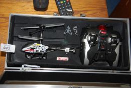 A cased remote control Helicopter.