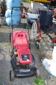 A 'Mountfield' self propelled garden mower with grass box - good compression.