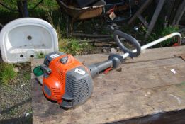 A 'Husqvarna' strimmer with bump feed.