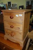 A Three drawer Pine bedside chest.