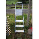 An Aluminum four rung step ladder.