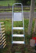 An Aluminum four rung step ladder.