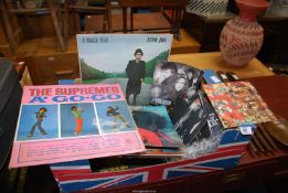 A box of LP's and 45's including Elton John, Band Aid, etc.