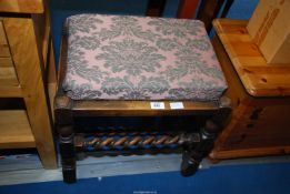 An Oak piano stool with barley twist stretchers.