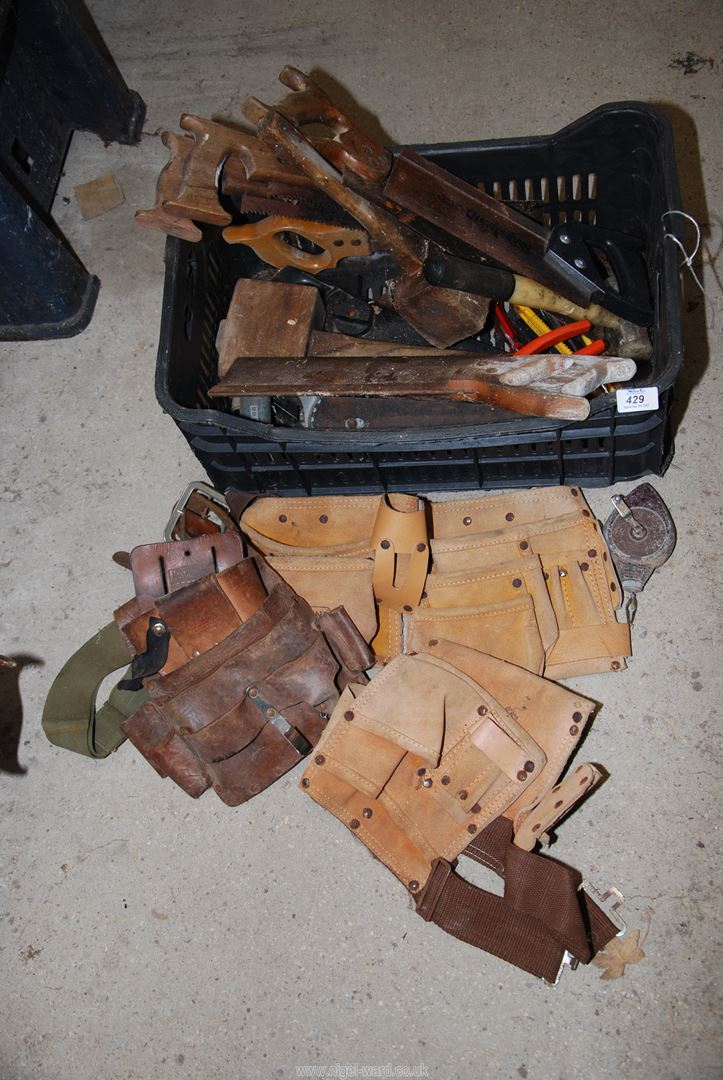 Various carpentry equipment, including: tool belts, handsaw, wooden mallets,and hacksaw etc.