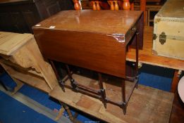 A small drop leaf table with end drawer.