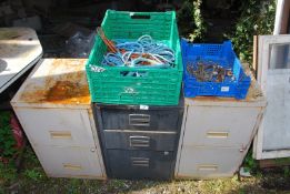 Three filing cabinets, a tray of spanners and a tub of rope.