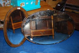 Two oval bevelled edged mirrors (one being frameless, one oak framed).