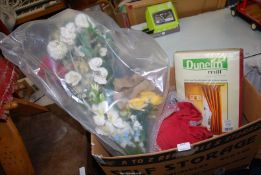 A box of curtains, artificial flowers, etc.