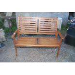 A Teak two seater garden bench, 47½" long.