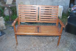 A Teak two seater garden bench, 47½" long.