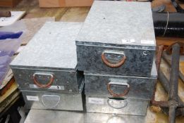 Five galvanised storage containers.