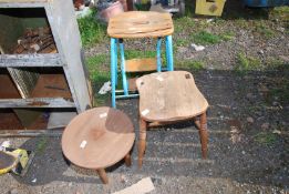 A foot rest pop up stool, old backless chair and kitchen table.