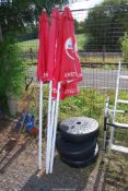 Three 'Amstel Bier' pub parasols with water bases.