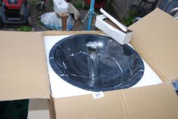 A circular marble wash basin - 17" diameter.