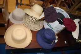 A quantity of mixed hats in hat boxes.