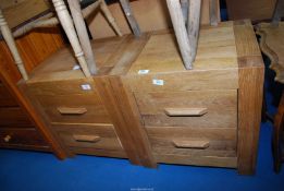 A pair of Oak bedside two drawer chests.