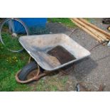 A large galvanised wheelbarrow with pneumatic tyres.