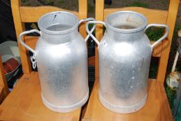 Two aluminum French milk churns without lids.