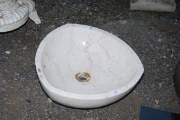 A white mottled granite sink, 19" diameter x 6" deep.