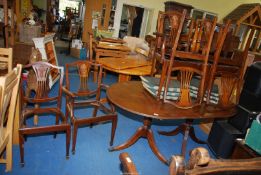 Regency style reproduction cross-banded Oval extending dining table with 4 chairs and 2 carvers.