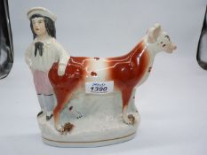 A Staffordshire creamer of a Cow and a boy.