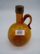 A Georgian hand blown, oval, amber glass flagon, with a brass collar to spout, probably for spirits,