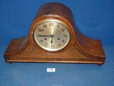 A two train movement Oak Napoleon mantle Clock with Arabic numerals. 18 1/2" wide x 10 1/2" high.