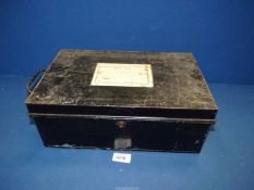 A black metal document tin with carrying handles either side, label to top,