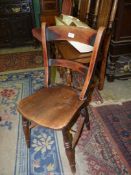 A bar back solid seated Elm seated kitchen Chair standing on turned legs to "H" stretcher.