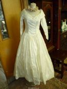A Rebecca Harte silk wedding dress with full skirt, three quarter length sleeves,