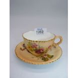 A Royal Worcester blush ivory cup and saucer, painted flowers and leaves gilt, uneven rim,