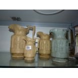 A graduated set of three Charles Meigh 'Apostle' moulded jugs in beige (A/F),
