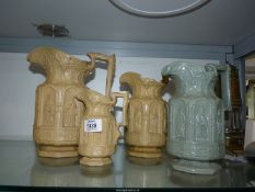 A graduated set of three Charles Meigh 'Apostle' moulded jugs in beige (A/F),