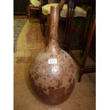 A brown long necked vase having interesting mottled glaze, 21 1/2" tall.