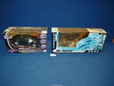 A remote control sports car and a remote control helicopter, both boxed.