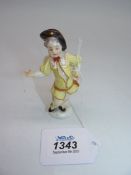 A small Meissen figure of a Cherub in disguise with impressed marks to base. 3 3/4" tall.