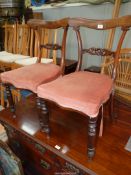 A pair of Mahogany/Rosewood serpentine fronted side Chairs standing on turned front legs and having
