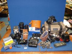 A quantity of cameras and binoculars including Haco 8 x 30 Field binoculars, Canon EOS 1000F camera,