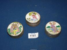Three small metal lidded pots having tops with ceramic inserts decorated in Oriental scenes and