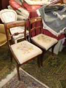 A pair of circa 1900 Mahogany framed side Chairs standing on sabre front legs and having an inset