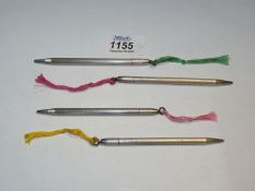 A set of four silver retractable pencils,