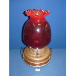 A Church heater/oil lamp with copper base, ruby red shade with fluted rim and chimney, 17 3/4" tall.