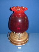 A Church heater/oil lamp with copper base, ruby red shade with fluted rim and chimney, 17 3/4" tall.