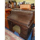 A dark Oak double pedestal roll-top Desk having a frieze drawer over the kneehole and four drawers