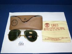 A pair of vintage Ray-Ban Aviator sunglasses with impact resistant lenses by Bausch & Lomb,