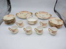 A floral and gilt finished six place Limoges for D & C Teaset (pattern 8993),